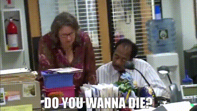 A Man And A Woman Are Sitting At A Desk In An Office With The Words `` Do You Wanna Die ? '' GIF