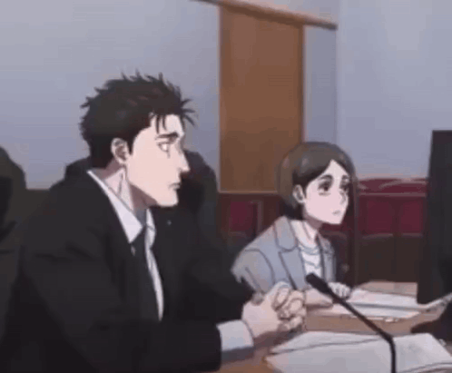 A Man And A Woman Are Sitting At A Desk In Front Of A Microphone . GIF