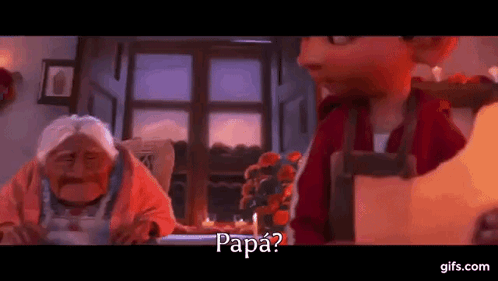 A Man And A Woman Are Sitting At A Table In A Room And The Man Is Asking The Woman If She Is Papa . GIF