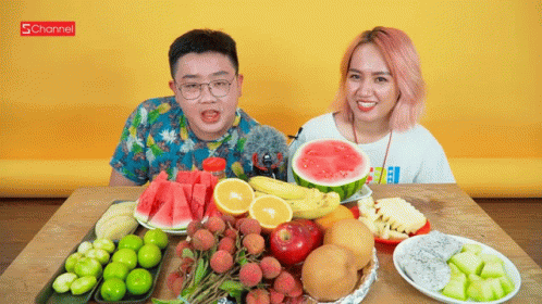 A Man And A Woman Are Sitting At A Table Surrounded By Fruits And Vegetables With A Schannel Logo In The Background GIF