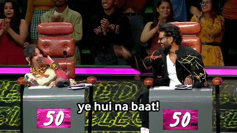 A Man And A Woman Are Sitting At A Table With 50 On It GIF