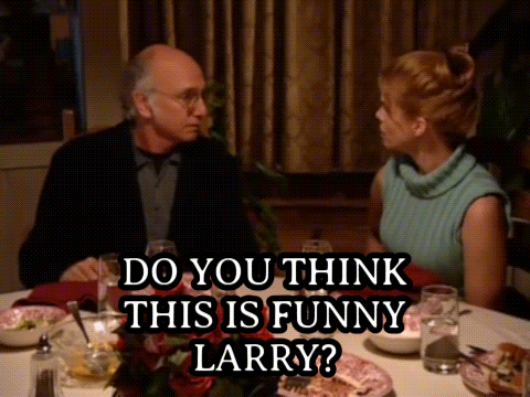 A Man And A Woman Are Sitting At A Table With A Caption That Says " Do You Think This Is Funny Larry " GIF