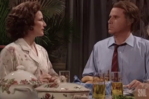 Man And Woman Sitting At Table With Casserole And Beer GIF
