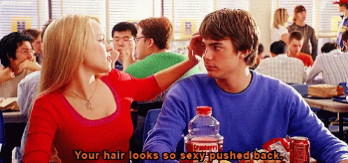 A Man And A Woman Are Sitting At A Table With A Coca Cola Bottle In Front Of Them . GIF