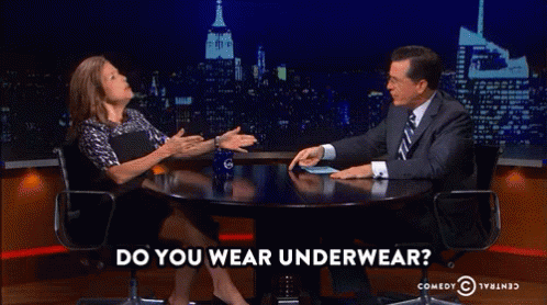 A Man And A Woman Are Sitting At A Table With The Words Do You Wear Underwear On The Bottom GIF