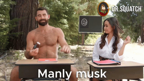 A Man And A Woman Are Sitting At Desks With The Words Manly Musk On The Bottom GIF