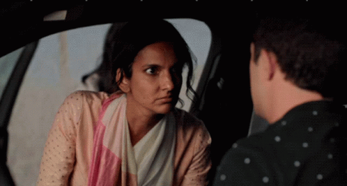 A Man And A Woman Are Sitting In A Car GIF