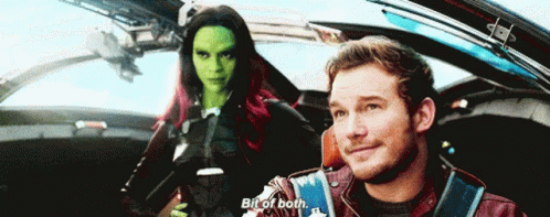 A Man And A Woman Are Sitting In A Car And The Man Is Saying Bit Of Both GIF