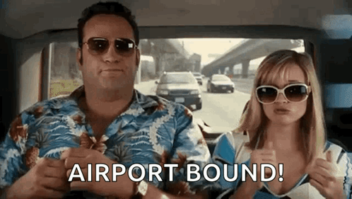 A Man And A Woman Are Sitting In A Car And The Woman Is Giving A Thumbs Up . GIF