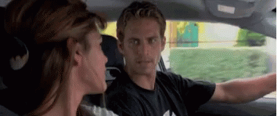 A Man And A Woman Are Sitting In A Car . GIF