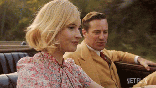 A Man And A Woman Are Sitting In A Car With Netflix Written On The Bottom Right GIF
