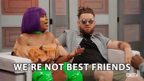 A Man And A Woman Are Sitting In A Chair With The Words We 'Re Not Best Friends Behind Them GIF