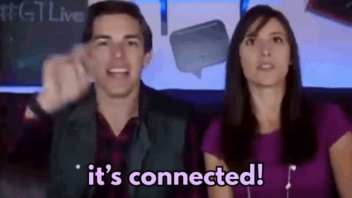 A Man And A Woman Are Sitting In Front Of A Sign That Says It 'S Connected .. GIF
