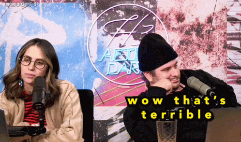 A Man And A Woman Are Sitting In Front Of Microphones And A Sign That Says Wow That 'S Terrible GIF