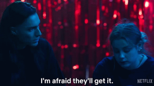 a man and a woman are sitting in front of red lights and the man says i 'm afraid they 'll get