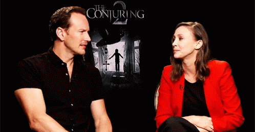 A Man And A Woman Are Sitting Next To Each Other And Laughing . GIF