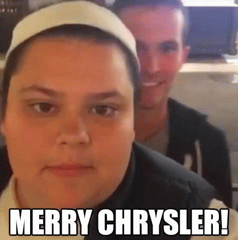 A Man And A Woman Are Sitting Next To Each Other And The Woman Is Wearing A Headband And The Man Is Smiling . GIF