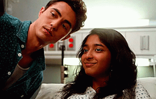 A Man And A Woman Are Sitting Next To Each Other In A Hospital Room . GIF