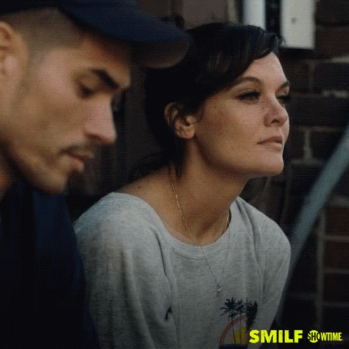 A Man And A Woman Are Sitting Next To Each Other On A Showtime Ad For Smilf GIF