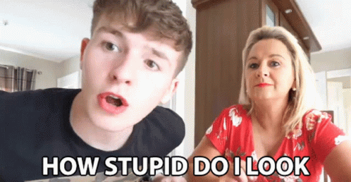 A Man And A Woman Are Sitting Next To Each Other With The Words How Stupid Do I Look On The Screen GIF