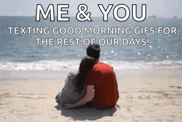 A Man And A Woman Are Sitting On A Beach Looking At The Ocean . GIF