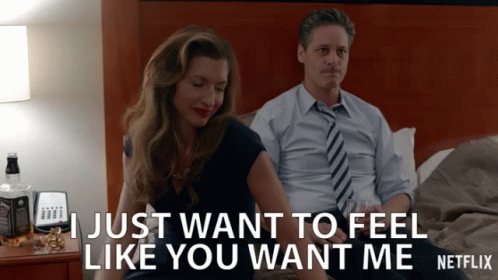 A Man And A Woman Are Sitting On A Bed And The Man Says " I Just Want To Feel Like You Want Me Netflix " GIF