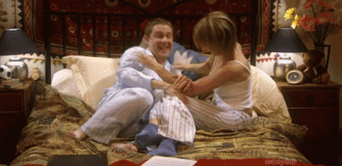 A Man And A Woman Are Sitting On A Bed With The Words Notmydate Written On The Bottom GIF