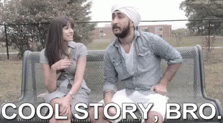A Man And A Woman Are Sitting On A Bench In A Park . GIF
