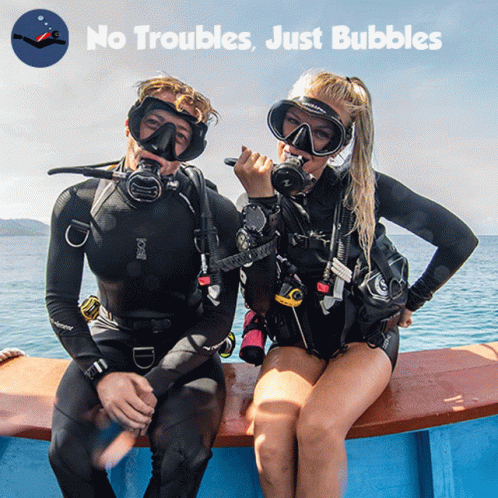 A Man And A Woman Are Sitting On A Boat With The Words " No Troubles Just Bubbles " Behind Them GIF