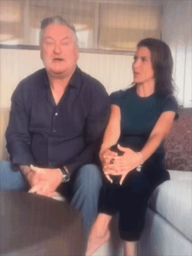 Man And Woman Sitting On Couch GIF