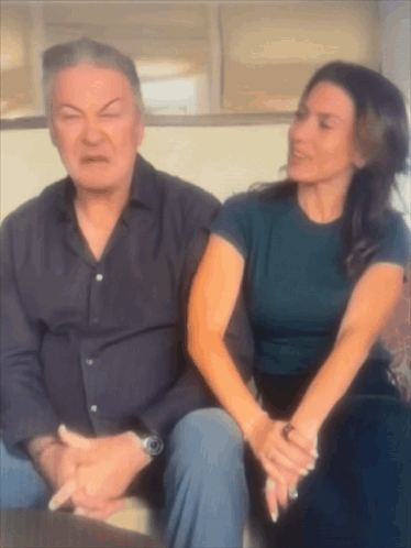 Man And Woman Sitting On Couch Woman Making Face GIF