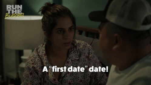 A Man And A Woman Are Sitting On A Couch And The Woman Is Saying " A First Date Date " GIF