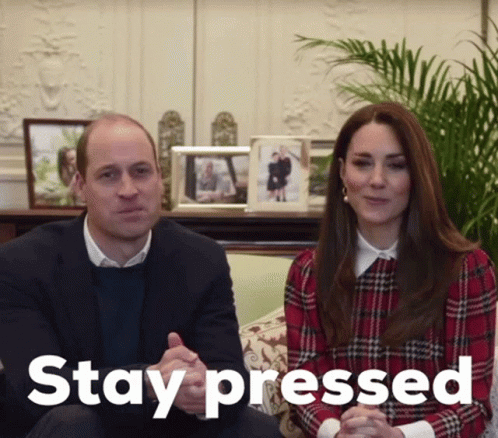 A Man And A Woman Are Sitting On A Couch With The Word Stay Pressed Behind Them GIF