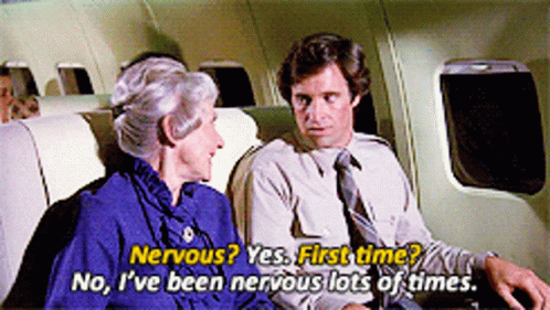 A Man And A Woman Are Sitting On A Plane And The Woman Is Saying Nervous Yes First Time GIF