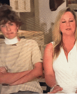 a man and a woman are sitting with their arms crossed