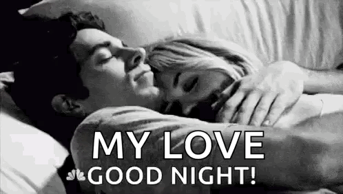 A Man And A Woman Are Sleeping In A Bed . GIF