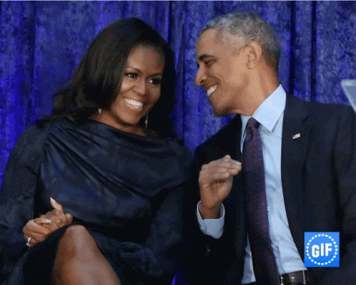 A Man And A Woman Are Smiling And Looking At Each Other In Front Of A Gif Logo GIF