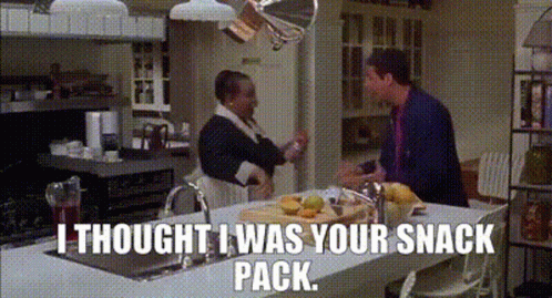 A Man And A Woman Are Standing In A Kitchen With The Words I Thought I Was Your Snack Pack . GIF