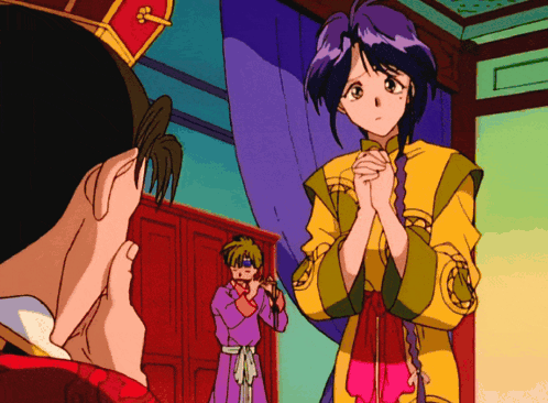 A Man And A Woman Are Standing In A Room And The Woman Is Wearing A Yellow Dress GIF
