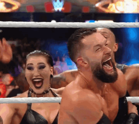 A Man And A Woman Are Standing In A Wrestling Ring With Their Mouths Wide Open GIF