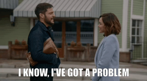 Man And Woman Standing In Front Of Building Saying I Know I Have A Problem GIF
