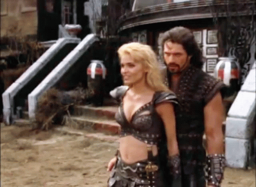 Man And Woman Standing In Front Of Building GIF