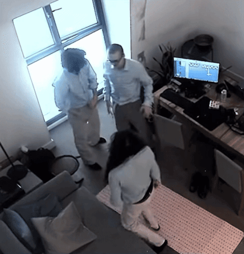 A Man And A Woman Are Standing In Front Of A Computer Monitor That Says ' Olympus ' On The Screen GIF