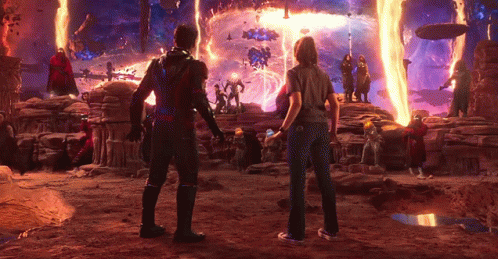 Man And Woman Standing In Front Of Fire GIF