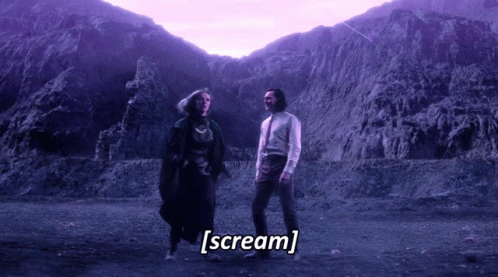 A Man And A Woman Are Standing In Front Of A Mountain And The Words Scream Are Written Below Them GIF