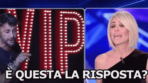 A Man And A Woman Are Standing In Front Of A Sign That Reads Vip GIF