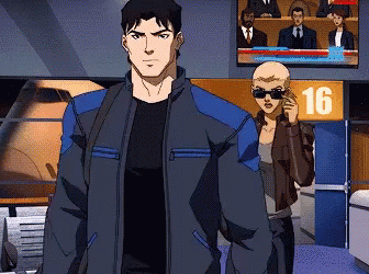 A Man And A Woman Are Standing In Front Of A Sign That Says 16 On It GIF