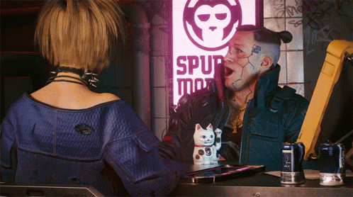 A Man And A Woman Are Standing In Front Of A Sign That Says Spur Man GIF