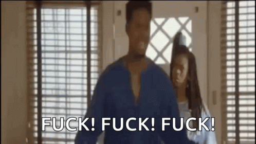 A Man And A Woman Are Standing In Front Of A Window . GIF