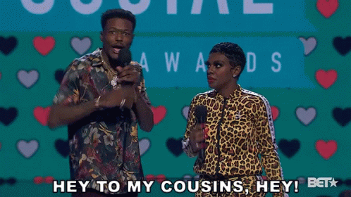 A Man And A Woman Are Standing In Front Of Microphones And Saying " Hey To My Cousins Hey " GIF